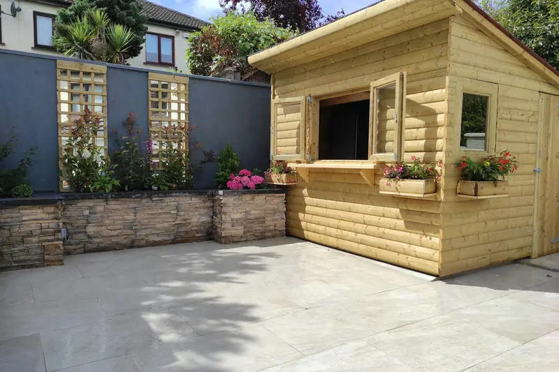 Patio beside a summerhouse and trellis
