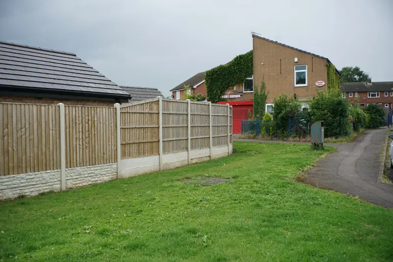 Fence panels on concrete posts with gravel boards