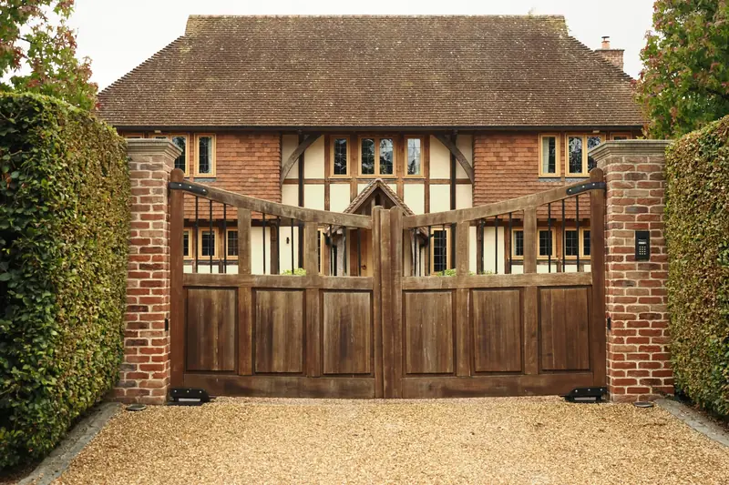 Timber driveway gates on brick piers